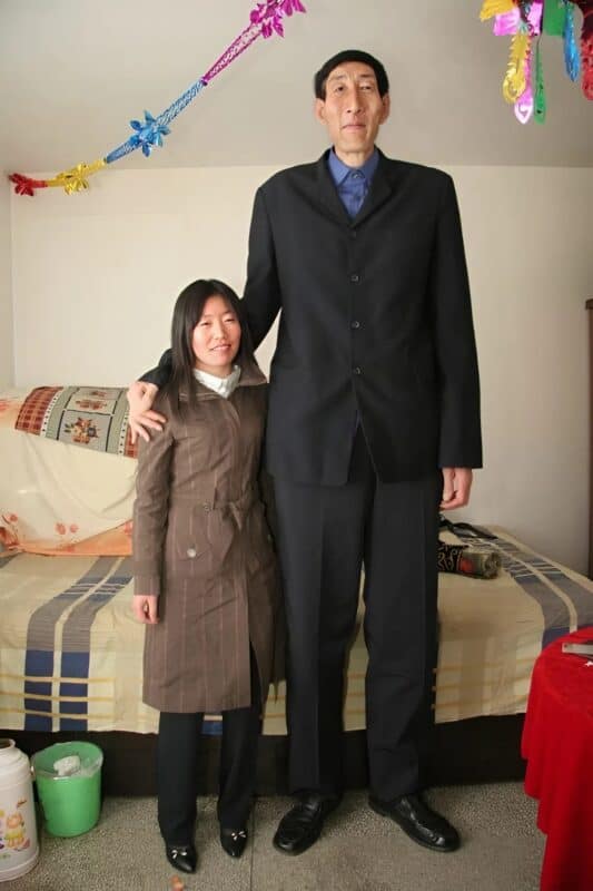 Son of the tallest man with his mother