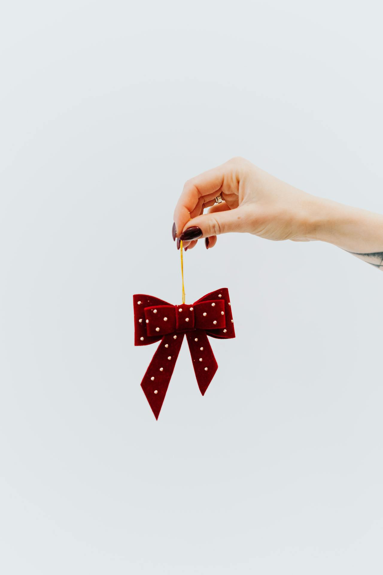 A woman holding a red ribbon | Source: Pexels